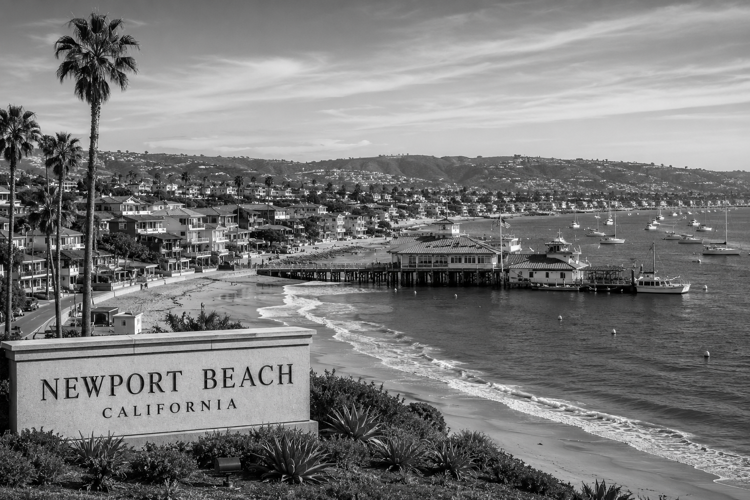 Stone sign reading "Newport Beach California" overlooking a coastal town with palm trees, houses, a pier, and sailboats in the water.